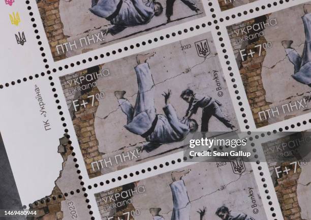 Newly-issued Ukrainian postage stamp features street art by British artist Banksy that shows a child throwing Russian President Vladimir Putin to the...