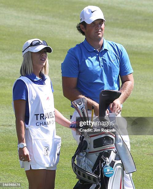 Patrick Reed and his caddie Justine Karain, who is also his fiancee, look over the first fairway during Final Round of the 2012 Travelers...