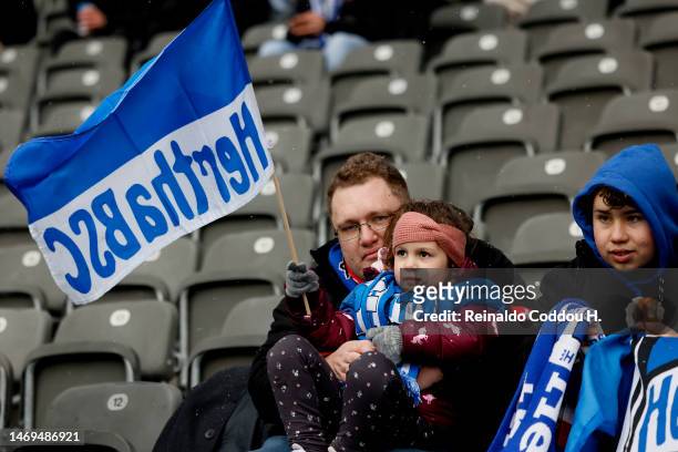 Hertha BSC fans wave flags inside the stadium prior to the Bundesliga match between Hertha BSC and FC Augsburg at Olympiastadion on February 25, 2023...