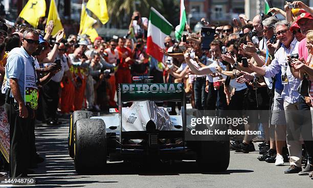 Michael Schumacher of Germany and Mercedes GP is applauded into parc ferme after finishing third during the European Grand Prix at the Valencia...