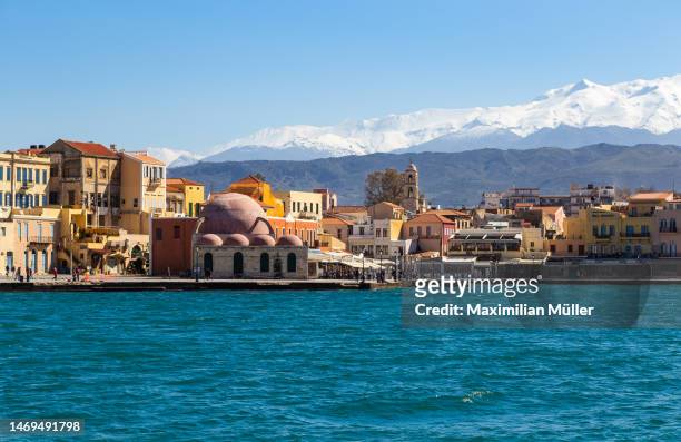 old town, chania, crete, greece in front a snow covered mountains - crete scenics stock pictures, royalty-free photos & images