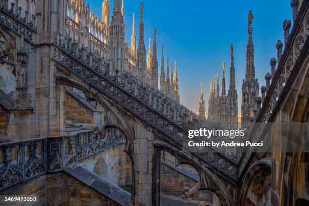 the spires of the duomo, milan cathedral, milan, lombardy, italy - guglia foto e immagini stock