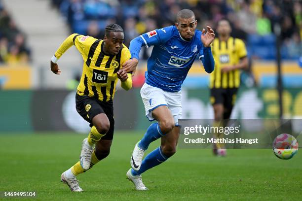 Jamie Bynoe-Gittens of Borussia Dortmund is challenged by Kevin Akpoguma of TSG Hoffenheim during the Bundesliga match between TSG Hoffenheim and...