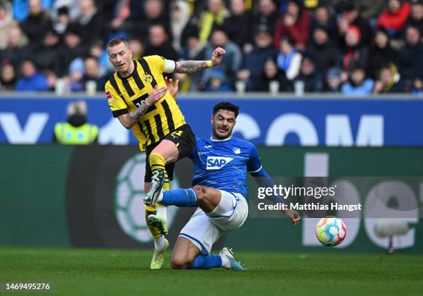 Marco Reus of Borussia Dortmund is fouled by Ozan Kabak of TSG Hoffenheim during the Bundesliga match between TSG Hoffenheim and Borussia Dortmund at...