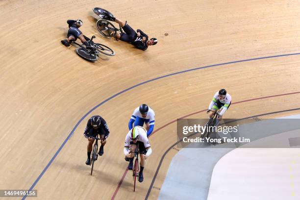 Muhammad Shah Firdaus Sahrom of Team Malaysia and Sam Dakin of Team New Zealand react after a crash as Harrie Lavreysen of Team Netherlands leads in...