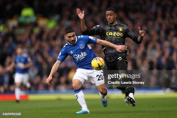 Neal Maupay of Everton runs with the ball whilst under pressure from Ezri Konsa of Aston Villa during the Premier League match between Everton FC and...