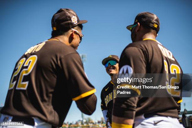 Manny Machado, Juan Soto and Nelson Cruz of the San Diego Padres talk before a spring training game against the Seattle Mariners at Peoria Stadium on...