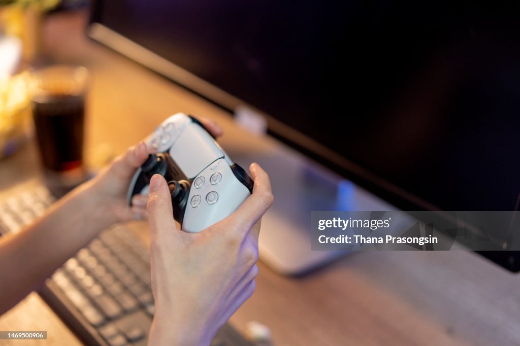 Close up female hands holding gamepad and playing videogames