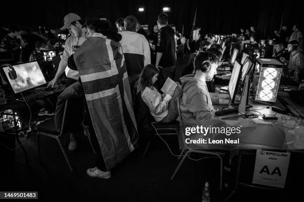 Woman reads a book as Esport competitors take part in a gaming tournament at the Epic.Lan 38 event on February 25, 2023 in Kettering, England. The...