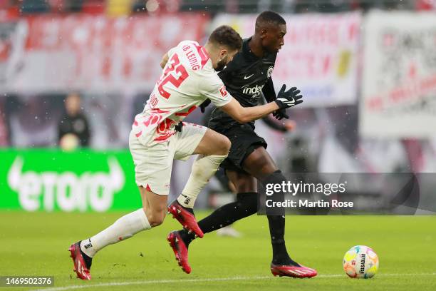 Randal Kolo Muani of Eintracht Frankfurt runs with the ball whilst under pressure from Josko Gvardiol of RB Leipzig during the Bundesliga match...