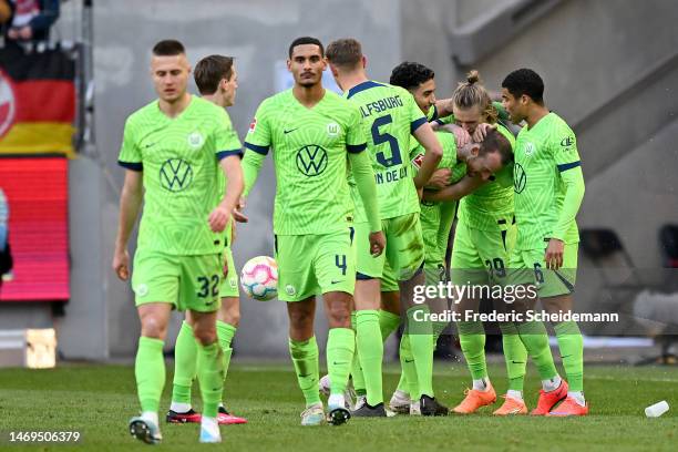 Maximilian Arnold of VfL Wolfsburg celebrates with team mates after scoring their sides second goal from the penalty spot during the Bundesliga match...