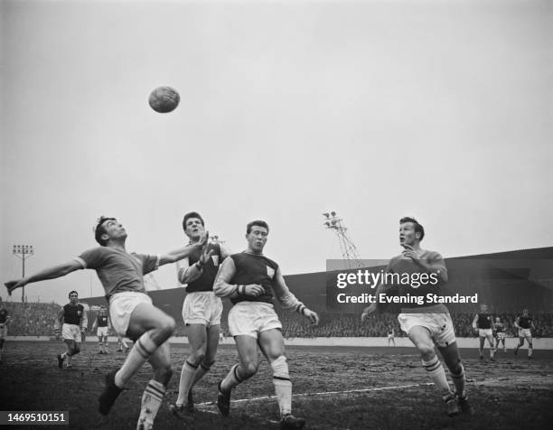 British footballer Alan Sealey, West Ham forward, and British footballer Malcolm Musgrove, West Ham midfielder, between two Chelsea footballers...