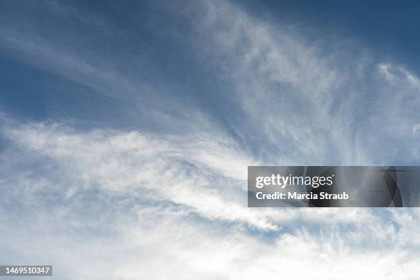 wispy  cirrus clouds sweeping across the sky - cirrocúmulo fotografías e imágenes de stock