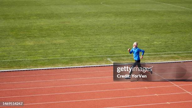 confident senior athlete running at the sports stadium - sports competition format stock pictures, royalty-free photos & images