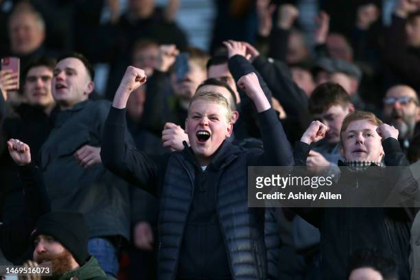 Fans of Millwall celebrate during the Sky Bet Championship match between Stoke City and Millwall at Bet365 Stadium on February 25, 2023 in Stoke on...