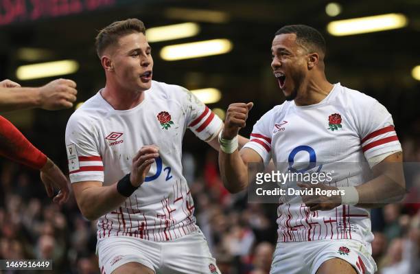 Anthony Watson of England celebrates scoring their side's first try with teammate Freddie Steward during the Six Nations Rugby match between Wales...