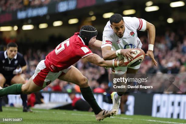 Anthony Watson of England scores their side's first try whilst under pressure from Leigh Halfpenny of Wales during the Six Nations Rugby match...