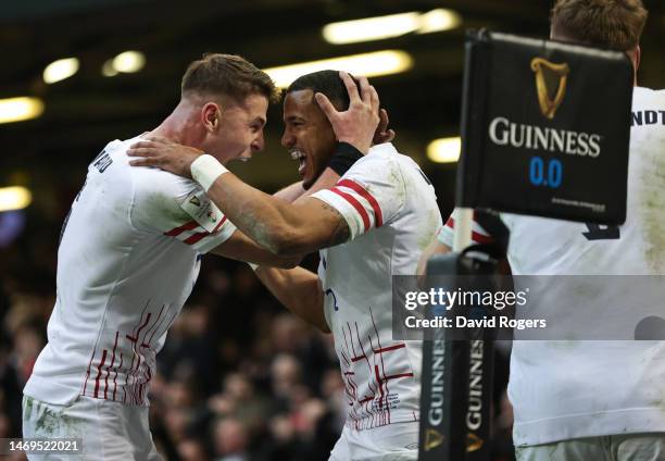 Anthony Watson of England celebrates scoring their side's first try with teammate Freddie Steward during the Six Nations Rugby match between Wales...