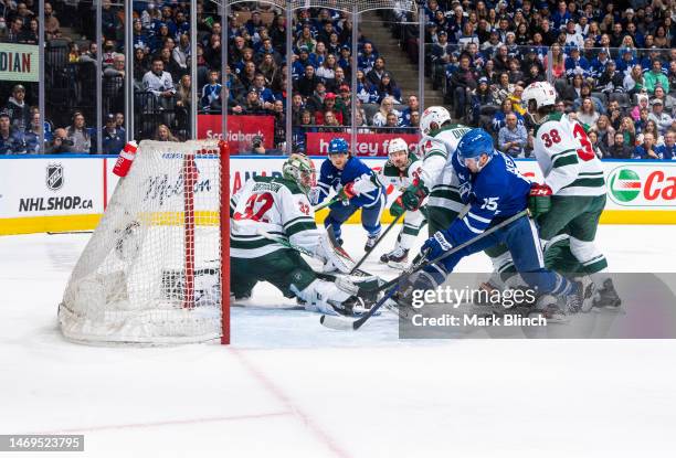 Alexander Kerfoot of the Toronto Maple Leafs goes to the net against Matt Dumba and Filip Gustavsson of the Minnesota Wild during the third period at...