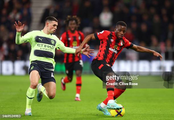 Hamed Junior Traore of AFC Bournemouth is challenged by Phil Foden of Manchester City during the Premier League match between AFC Bournemouth and...