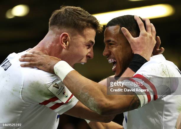 Anthony Watson of England celebrates scoring their side's first try with teammate Freddie Steward during the Six Nations Rugby match between Wales...