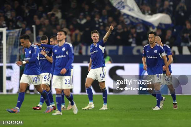 Marius Buelter of FC Schalke 04 celebrates with teammates after scoring the team's second goal during the Bundesliga match between FC Schalke 04 and...