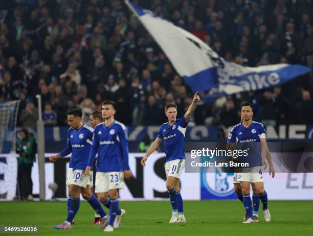 Marius Buelter of FC Schalke 04 celebrates with teammates after scoring the team's second goal during the Bundesliga match between FC Schalke 04 and...