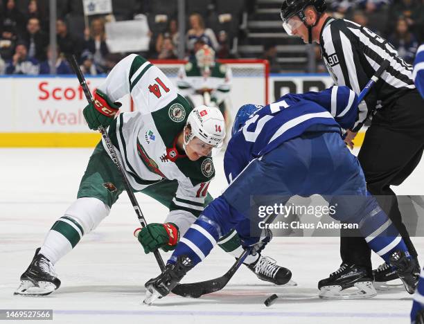 Joel Eriksson Ek of the Minnesota Wild takes a faceoff against David Kampf of the Toronto Maple Leafs during an NHL game at Scotiabank Arena on...