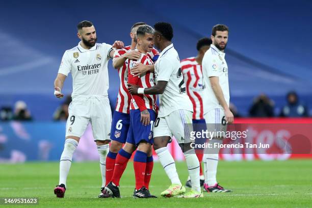 Vinicius Junior of Real Madrid clashes with Angel Correa of Atletico Madrid during the LaLiga Santander match between Real Madrid CF and Atletico de...