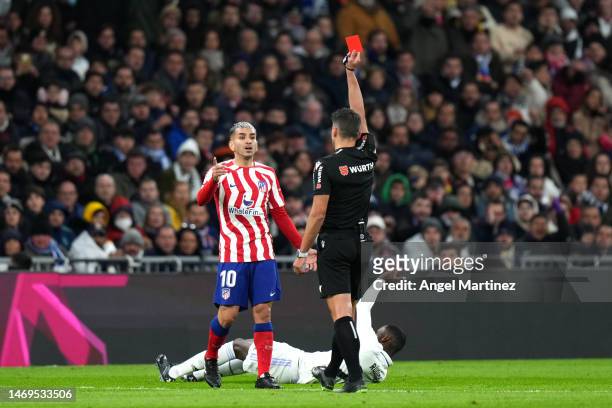 Angel Correa of Atletico Madrid is shown a red card by Match Referee Jesus Gil Manzano during the LaLiga Santander match between Real Madrid CF and...