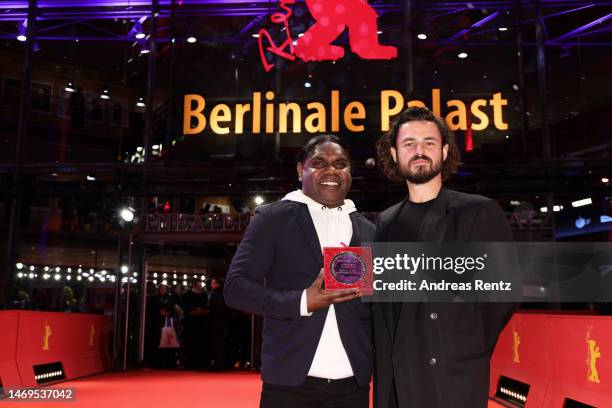 Derik Lynch and Matthew Thorne pose on the red carpet with the Silver Bear Jury Prize for their film "Marungka Tjalatjunu" after the award ceremony...