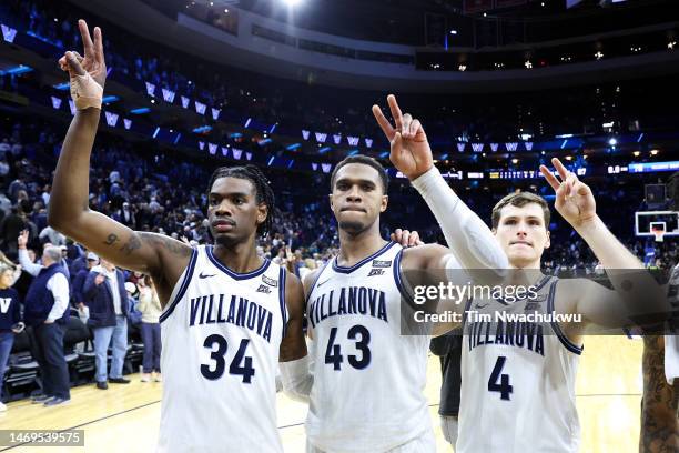 Brandon Slater, Eric Dixon and Chris Arcidiacono of the Villanova Wildcats react after defeating the Creighton Bluejays at Wells Fargo Center on...