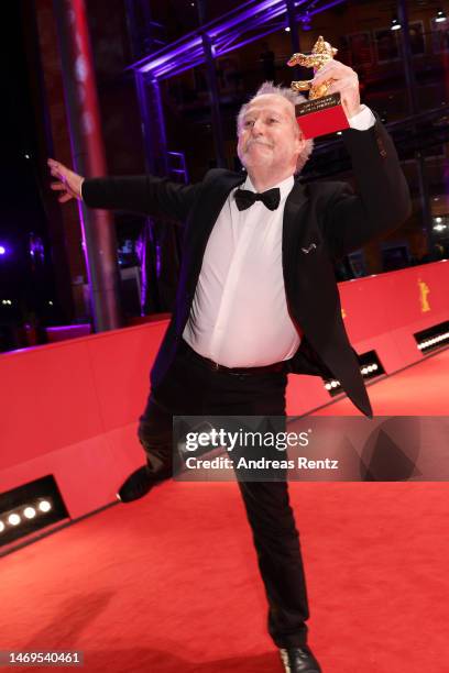 Nicolas Philibert holds the Golden Bear for Best Film won for his Film "Sur l’Adamant" on the red carpet after the award ceremony of the 73rd...