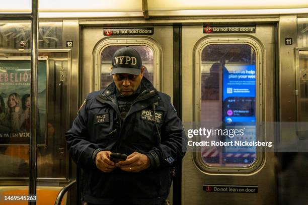 New York Police Department officer assigned with the Transit Bureaus Anti Terrorism Unit checks his iPhone at a subway stationFebruary 24, 2023 in...