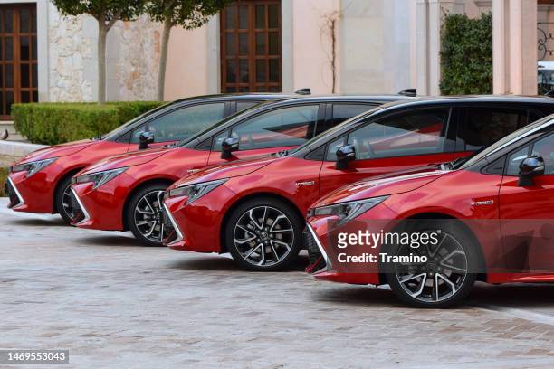 compact toyota cars on a parking - compact car stockfoto's en -beelden