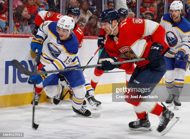 Peyton Krebs of the Buffalo Sabres and Sam Reinhart of the Florida Panthers chase a loose puck at the FLA Live Arena on February 24, 2023 in Sunrise,...