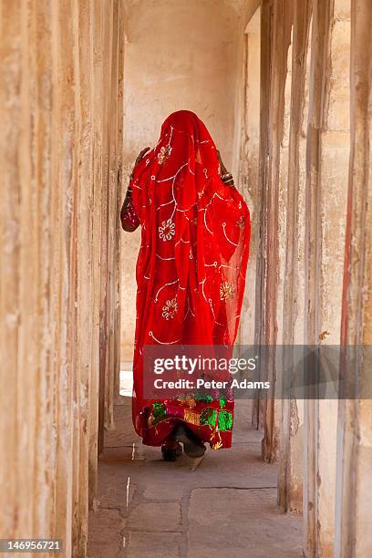 woman wearing sari, meherangarh fort, india - woman in red sari stock-fotos und bilder