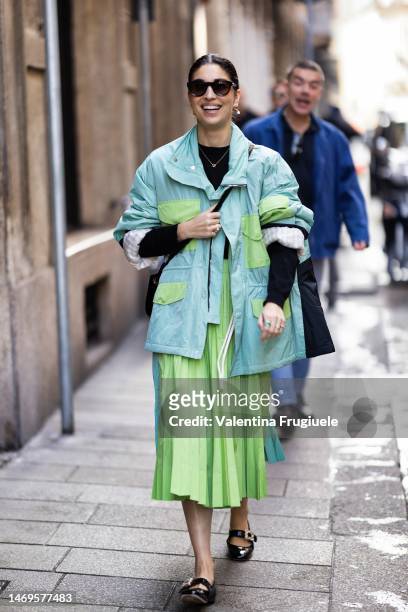 Caroline Issa is seen wearing a blue and green cargo jacket and green pleated skirt outside the Ferrari show during the Milan Fashion Week Womenswear...