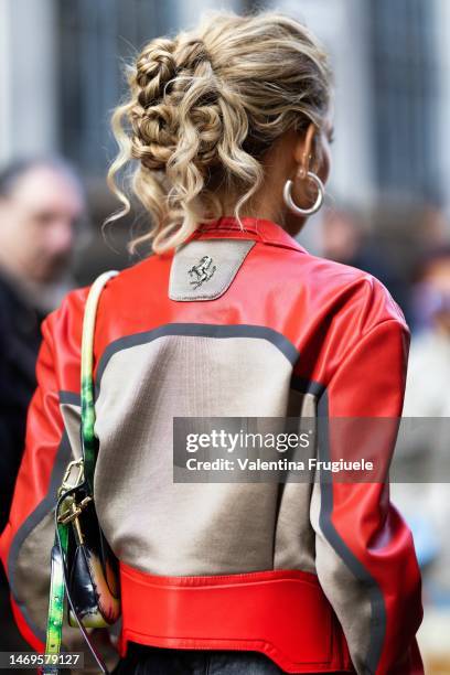 Emili Sindlev is seen wearing a red leather zipper jacket, curly bun and round circle earrings outside the Ferrari show during the Milan Fashion Week...