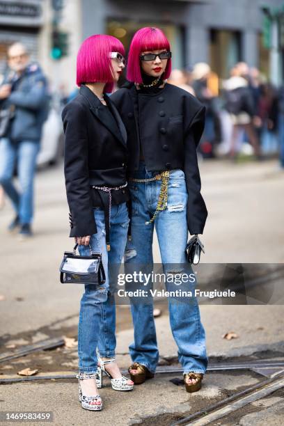 Ami and Aya Suzuki are seen wearing cropped blazer, denim pants, silver necklace, D&G sunglasses, gold chain belt outside the Dolce & Gabbana show...