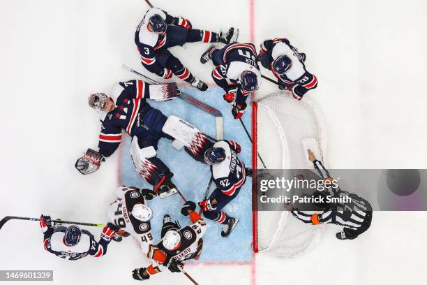 Goalie Charlie Lindgren of the Washington Capitals cannot make a save on a goal scored by Troy Terry of the Anaheim Ducks as players crash the net...