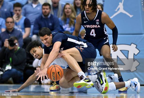 Puff Johnson of the North Carolina Tar Heels battles Kadin Shedrick of the Virginia Cavaliers for a loose ball during the first half of their game at...