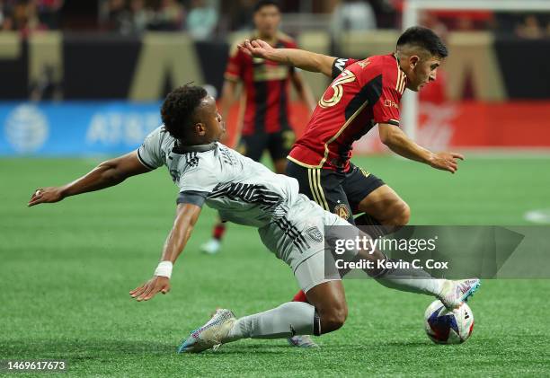 Jeremy Ebobisse of the San Jose Earthquakes challenges Thiago Almada of Atlanta Unitedduring the first half at Mercedes-Benz Stadium on February 25,...