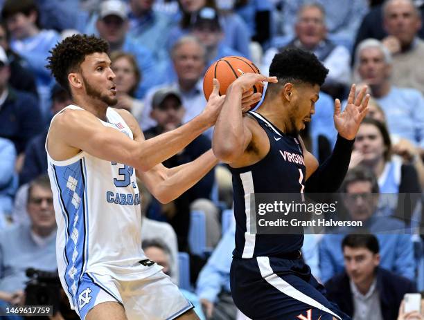 Jayden Gardner of the Virginia Cavaliers loses the ball to Pete Nance of the North Carolina Tar Heels during the second half of their game at the...