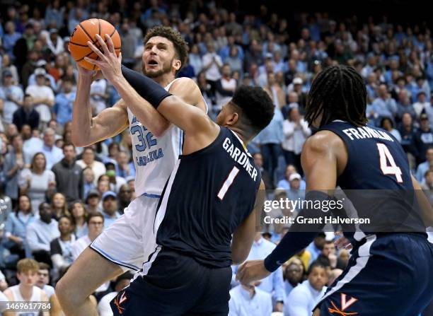 Jayden Gardner of the Virginia Cavaliers fouls Pete Nance of the North Carolina Tar Heels during the second half of their game at the Dean E. Smith...