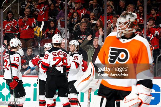 The New Jersey Devils react with Dawson Mercer after his goal scored during the second period against the Philadelphia Flyers at Prudential Center on...