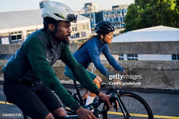 cycling sports and couple of friends travel, fitness or marathon training in urban city competition or race. exercise bicycle of athlete black people with teamwork, triathlon journey and safety gear - triathlon gear stock pictures, royalty-free photos & images