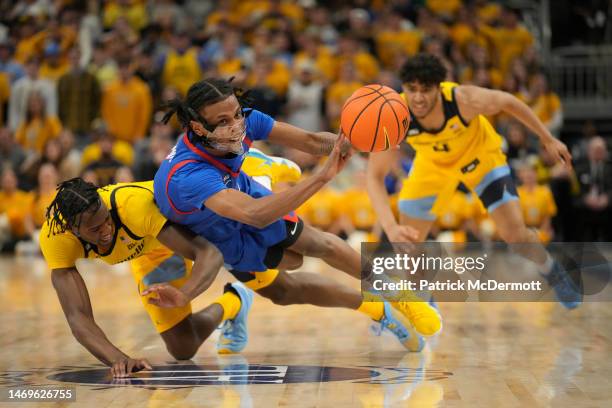 Olivier-Maxence Prosper of the Marquette Golden Eagles and Philmon Gebrewhit of the DePaul Blue Demons run for a loose ball in the second half at...