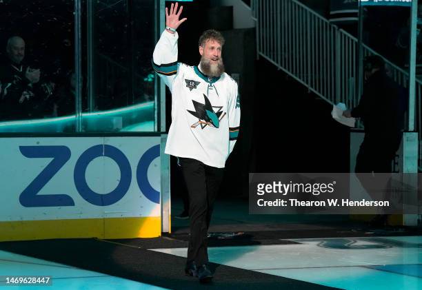 Former San Jose Sharks Joe Thornton walks onto the ice to greet former teammate Patrick Marleau who's speaking during a pregame ceremony to retire...