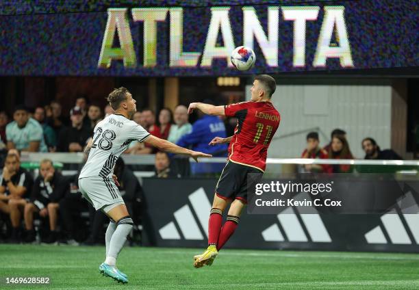 Brooks Lennon of Atlanta United leaps for a header against Benji Kikanovic of the San Jose Earthquakes during the second half at Mercedes-Benz...